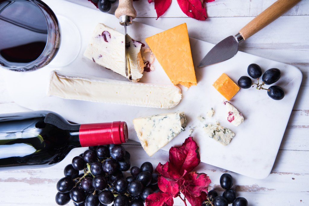 autumn snack selection with cheese and wine, overhead