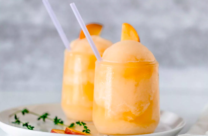 STYLECASTER | 17 Easy Blender Cocktails That Make Any Day Feel Like Vacation | Peach Bellini