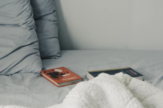 STYLECASTER | Zodiac Signs Zoom Background | books on bed