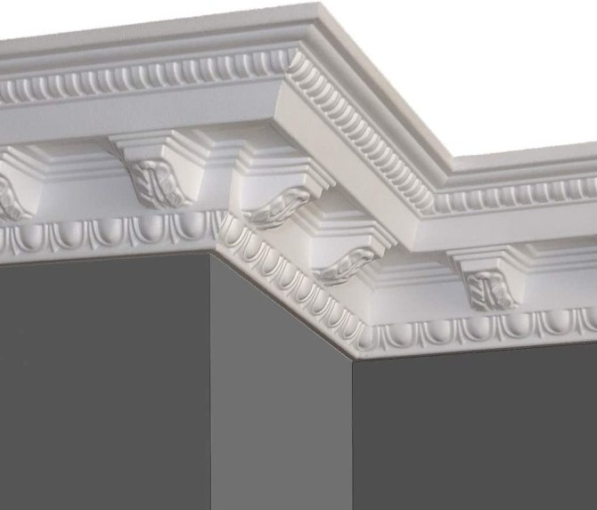 A dark gray wall lined with ornate white crown molding