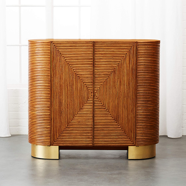 A small bar cabinet that's lined with fluted rattan