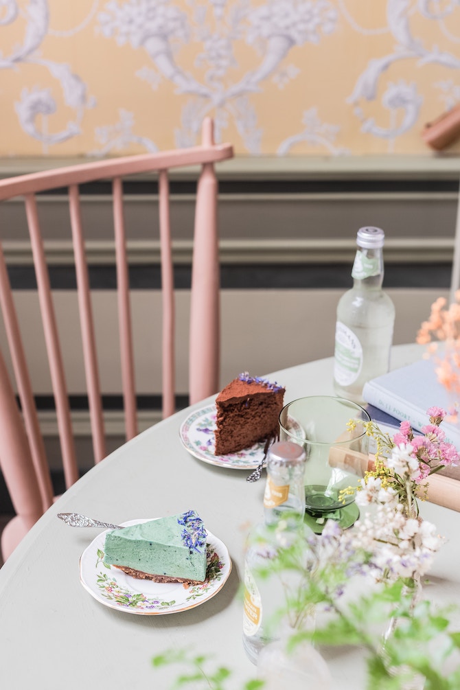 A table topped with flowers and slices of cake