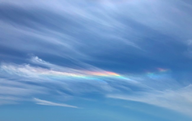 Colorful iridescent streaks of clouds in the sky