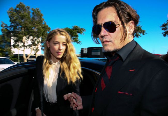 US actor Johnny Depp (R) and his wife Amber Heard arrive at a court in the Gold Coast on April 18, 2016. 
Depp and Heard arrived at an Australian court April 18 over Heard's alleged illegal importation of their two Yorkshire terrier dogs Boo and Pistol into the country in a private jet in 2015