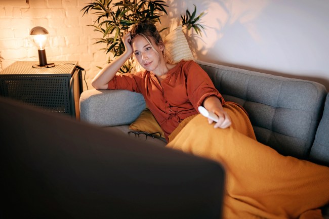 Young women watching tv at home.