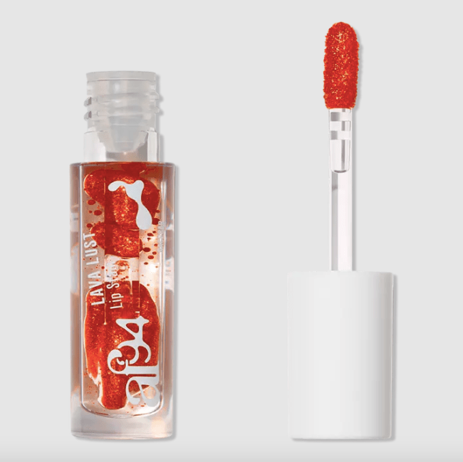 An orange colored lip stain that resembles a lava lamp in a clear bottle.