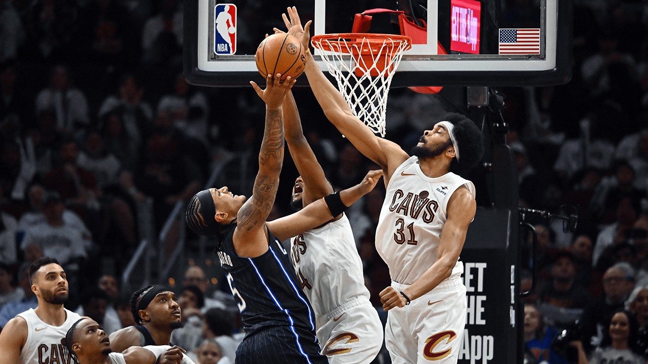 Evan Mobley #4 and Jarrett Allen #31 of the Cleveland Cavaliers block Paolo Banchero #5 of the Orlando Magic during the fourth quarter of game two of the Eastern Conference First Round Playoffs at Rocket Mortgage Fieldhouse on April 22, 2024 in Cleveland, Ohio. The Cavaliers defeated the Magic 96-86.