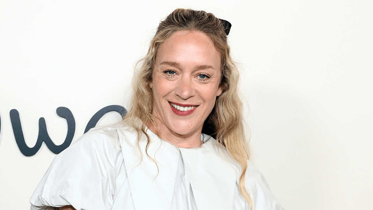 Chloë Sevigny wearing a white bubble dress and a black hair bow.