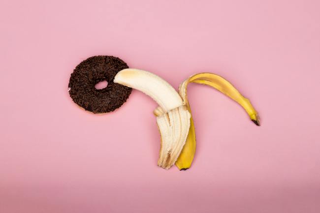 A banana entering a donut hole as a representation of vaginal intercourse