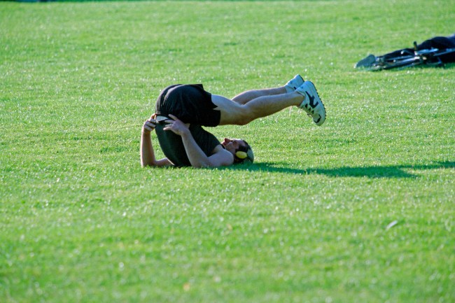John Kennedy Jr. stretching and exercising in short in Central Park, June 4, 1998.