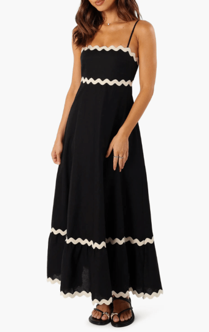 A model wearing the Petal & Pup Yana Sleeveless Maxi Dress in black