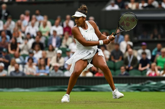 Naomi Osaka of Japan in action against Emma Navarro of the United States in the Ladies' Singles second round match during day three of The Championships Wimbledon 2024 at All England Lawn Tennis and Croquet Club on July 03, 2024 in London, England.