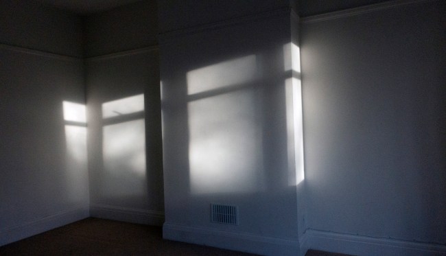 light from windows create shadows in an empty room
