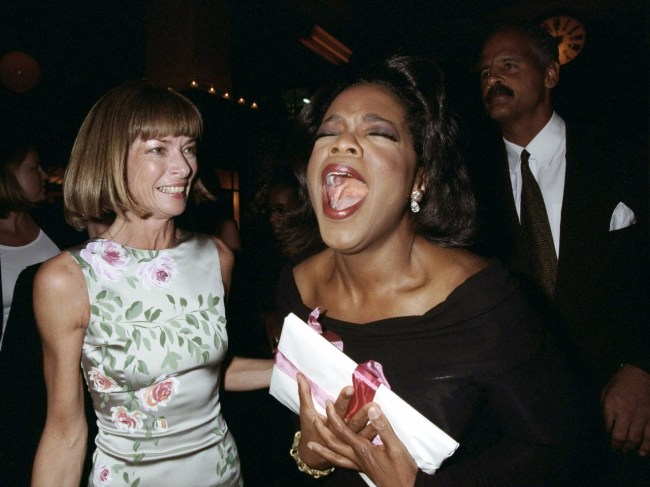 Vogue editor Anna Wintour looks on as Oprah Winfrey emotes at party at Balthazar promoting Vogue's October issue with Winfrey's picture on the cover.