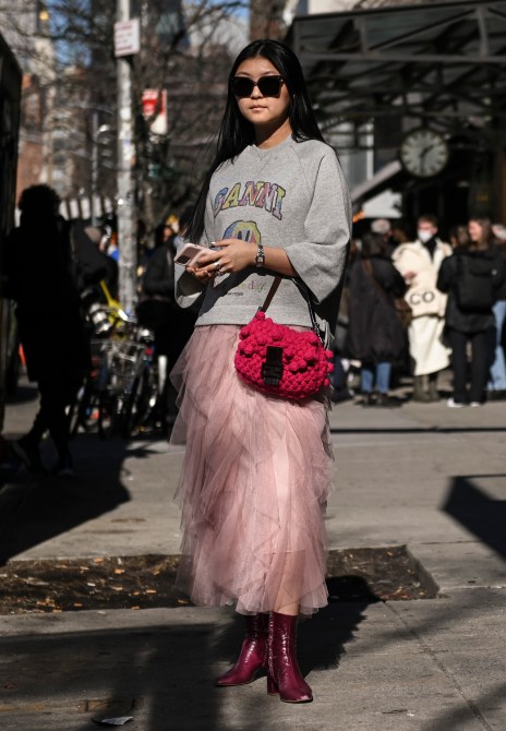 A guest is seen wearing a Ganni sweatshirt, pink tule skirt and red bag outside the Bronx and Banco show during New York Fashion Week A/W 2022 on February 11, 2022 in New York City.