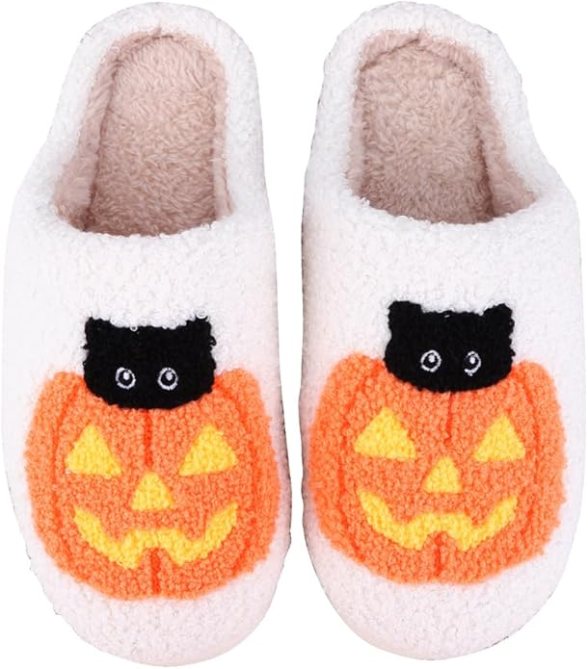 A pair of slippers with a cat inside of a pumpkin