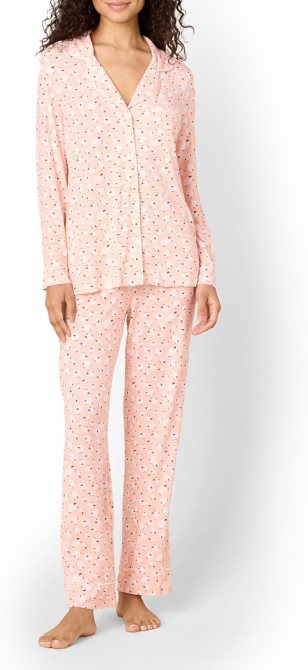 A woman wearing pink patterned pajamas from the Sofia Grainge x Amazon Essentials collection