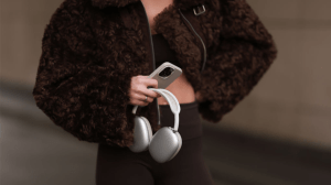 BERLIN, GERMANY - JANUARY 31: Sophia Geiss is seen wearing a cropped brown faux shearling jacket with wide sleeves from The Frankie Shop, a dark brown sports bra underneath, paired with dark brown leggings from Lululemon, and a silver ring, while holding AirPods and an iPhone during Berlin Fashion Week on January 31, 2025 in Berlin, Germany.