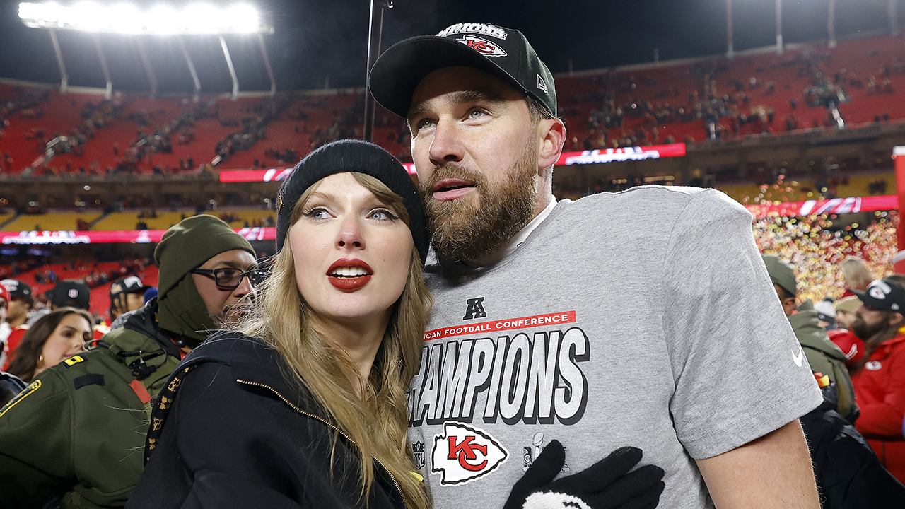 KANSAS CITY, MISSOURI - JANUARY 26: Taylor Swift celebrates with Travis Kelce #87 of the Kansas City Chiefs after defeating the Buffalo Bills 32-29 in the AFC Championship Game at GEHA Field at Arrowhead Stadium on January 26, 2025 in Kansas City, Missouri.