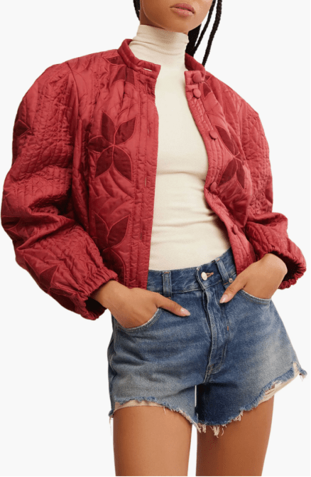 A model wearing the Free People Quinn Quilted Crop Jacket in a Marsala red colorway