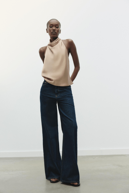 A model wearing the Zara Satin Effect Halter Top in beige