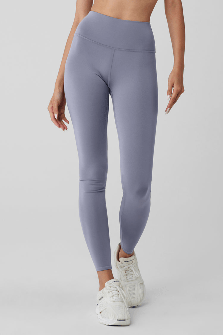 A model wearing the Alo Yoga High-Waist Airlift Legging in a light purple Fog colorway