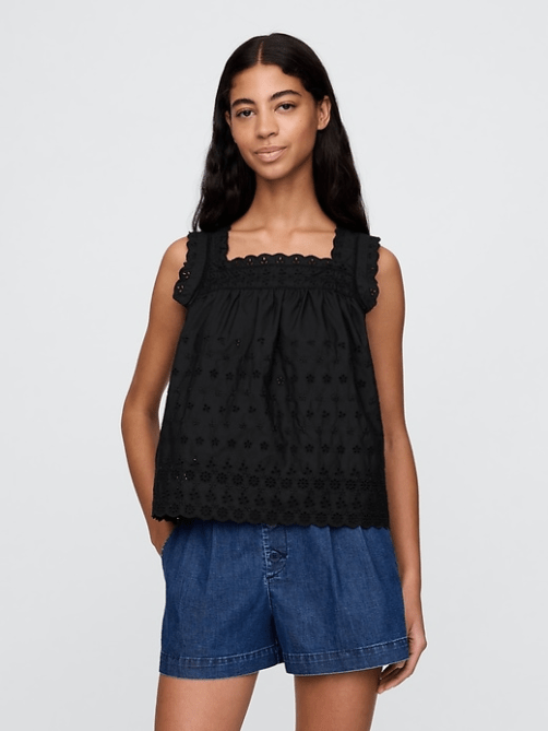 A model wearing the Gap x Dôen Eyelet Top in black