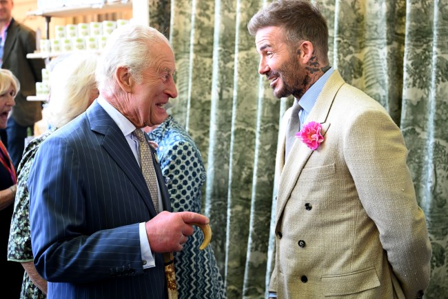 LONDON, ENGLAND - MAY 20: David Beckham wearing a David Austin Roses "King's Rose" speaks with King Charles III, patron of the Royal Horticultural Society at the Highgrove stand during a visit to the RHS Chelsea Flower Show at Royal Hospital Chelsea on May 20, 2025 in London, England.