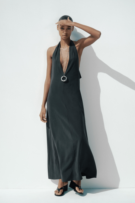 A model wearing the Zara Halter Tie Midi Dress in black