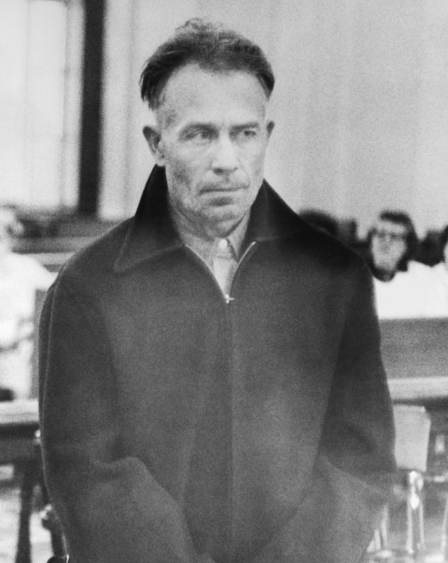 (Original Caption) Edward Gein, 51-year-old farmer, is shown in Wautoma court where he was arraigned on charges of armed robbery Monday after his arrest following discovery of a truck owned by a hardware store which was robbed recently. The truck was found parked beside a shed on Gein's farm. Further search uncovered the body of the store owner, Mrs. Bernie Worden. Since then 10 skulls were found, but today the grisly figure jumped to 15 when remains of more bodies were found after a new search of Gein's dilapidated Wisconsin home, where he has lived for the last 12 years alone.