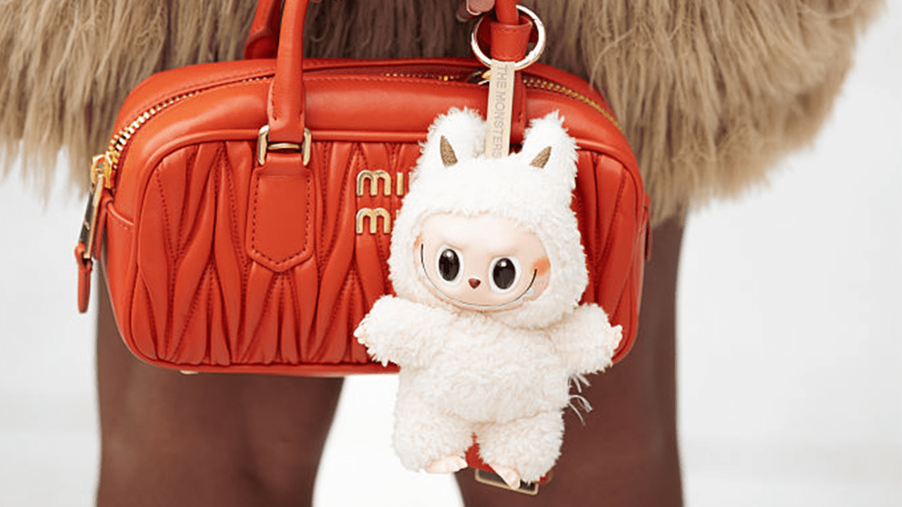 COPENHAGEN, DENMARK - AUGUST 07: Zufi Alexander wears beige mini skirt made of fur, orange MiuMiu bag with beige Labubu charm, purple, yellow and orange stripped long sleeve top during Copenhagen Fashion Week day four on August 07, 2025 in Copenhagen, Denmark. (Photo by Raimonda Kulikauskiene/Getty Images)