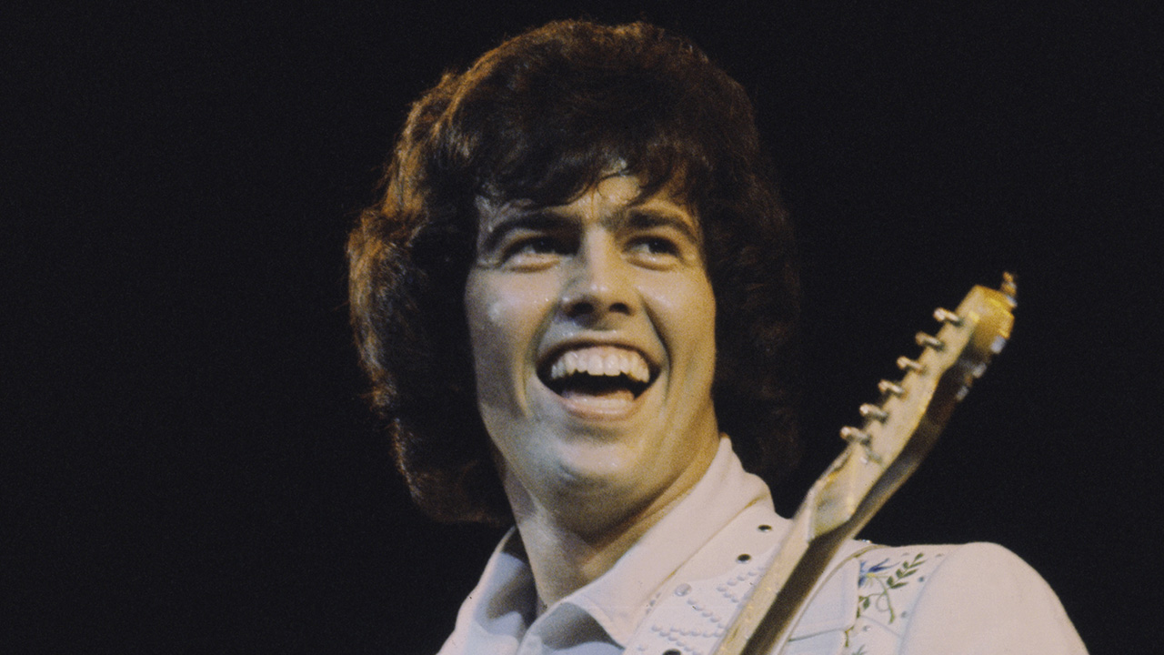 Musician and guitarist Alan Osmond performs live on stage with American family pop group The Osmonds on the British leg of their European tour, October 1973.